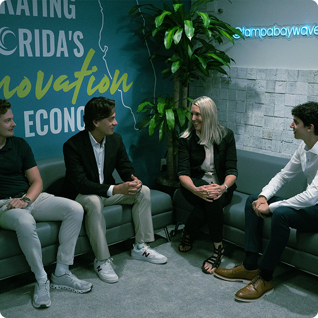 male and female team members meet in a modern lounge area at the tampa bay wave building in the tmrd