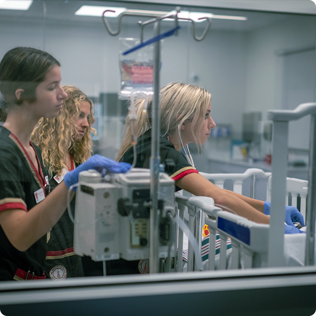 university of tampa female medical students operating medical machines in a research laboratory